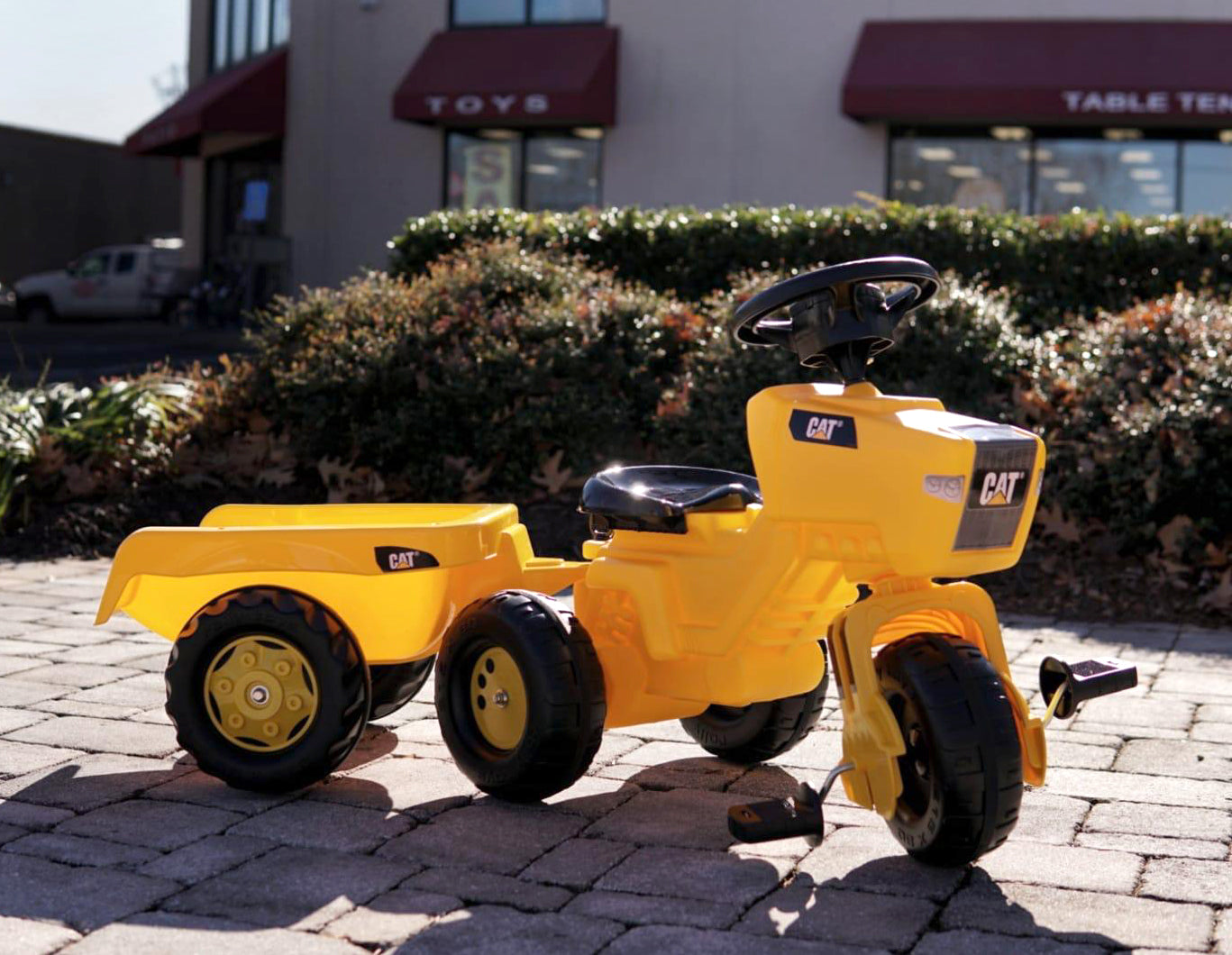 Lifestyle shot of pedal vehicle with trailer