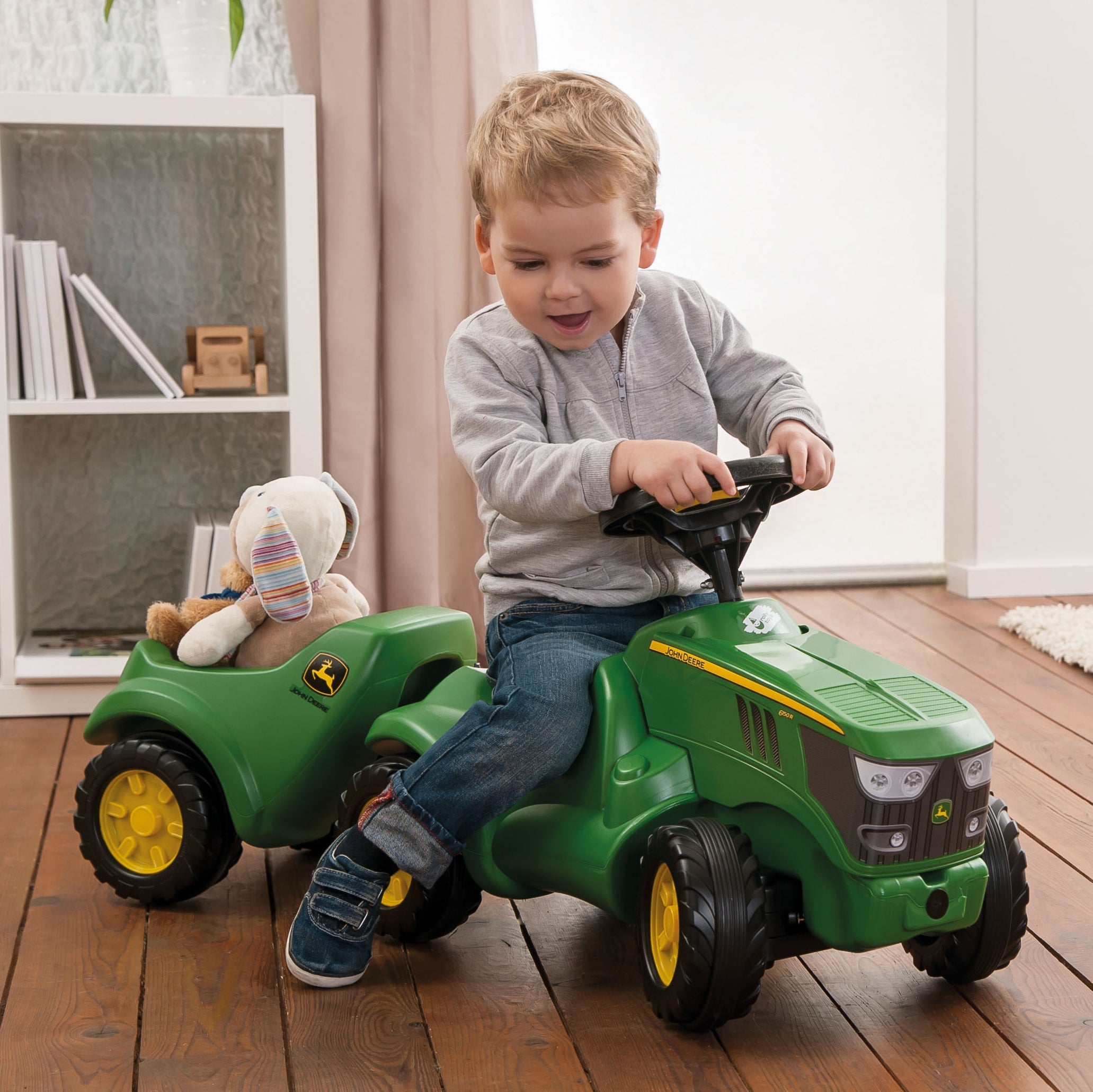 toddler riding on john deere resin foot to floor vehicle