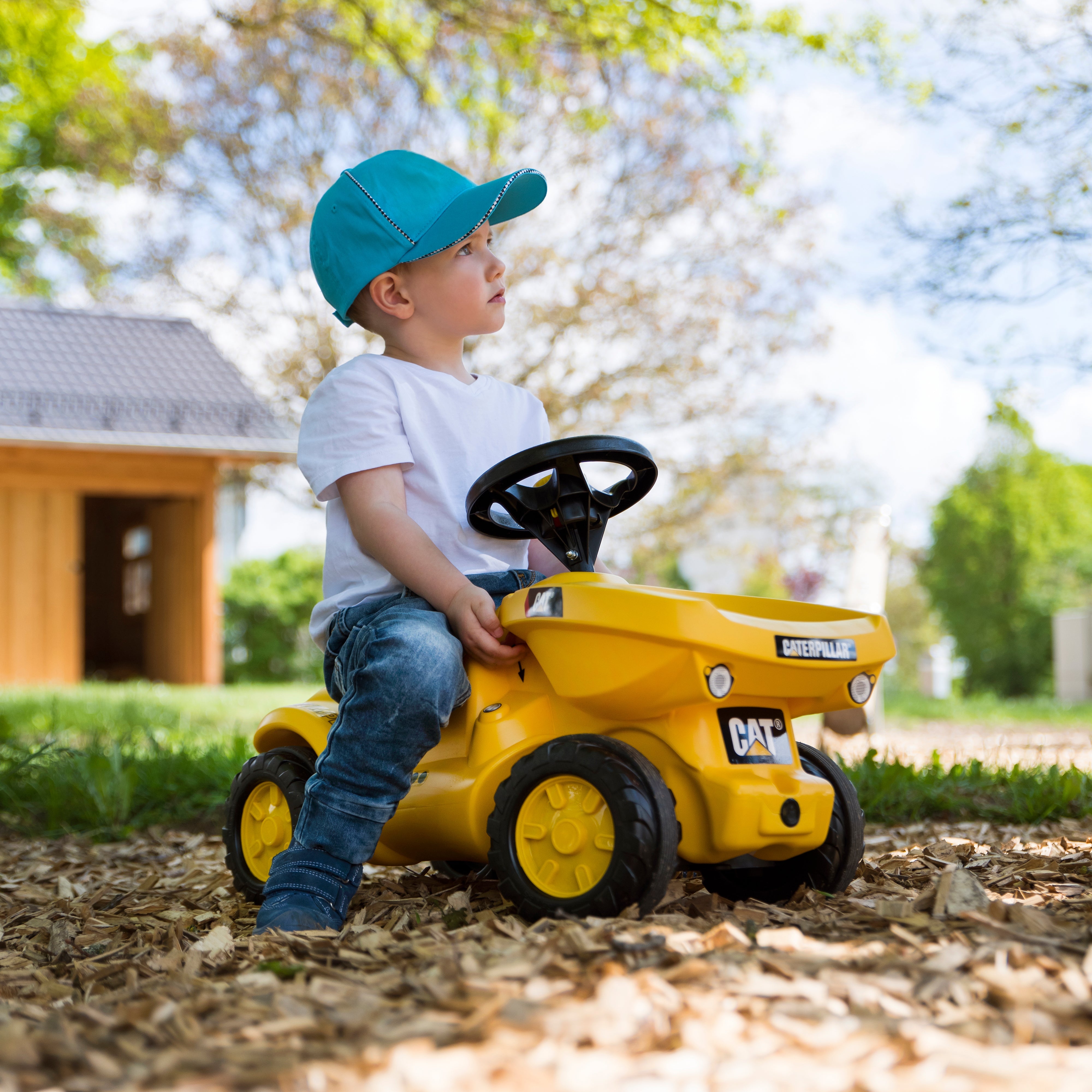 Lifestyle picture of boy using made in germany CAT resin ride on vehicle