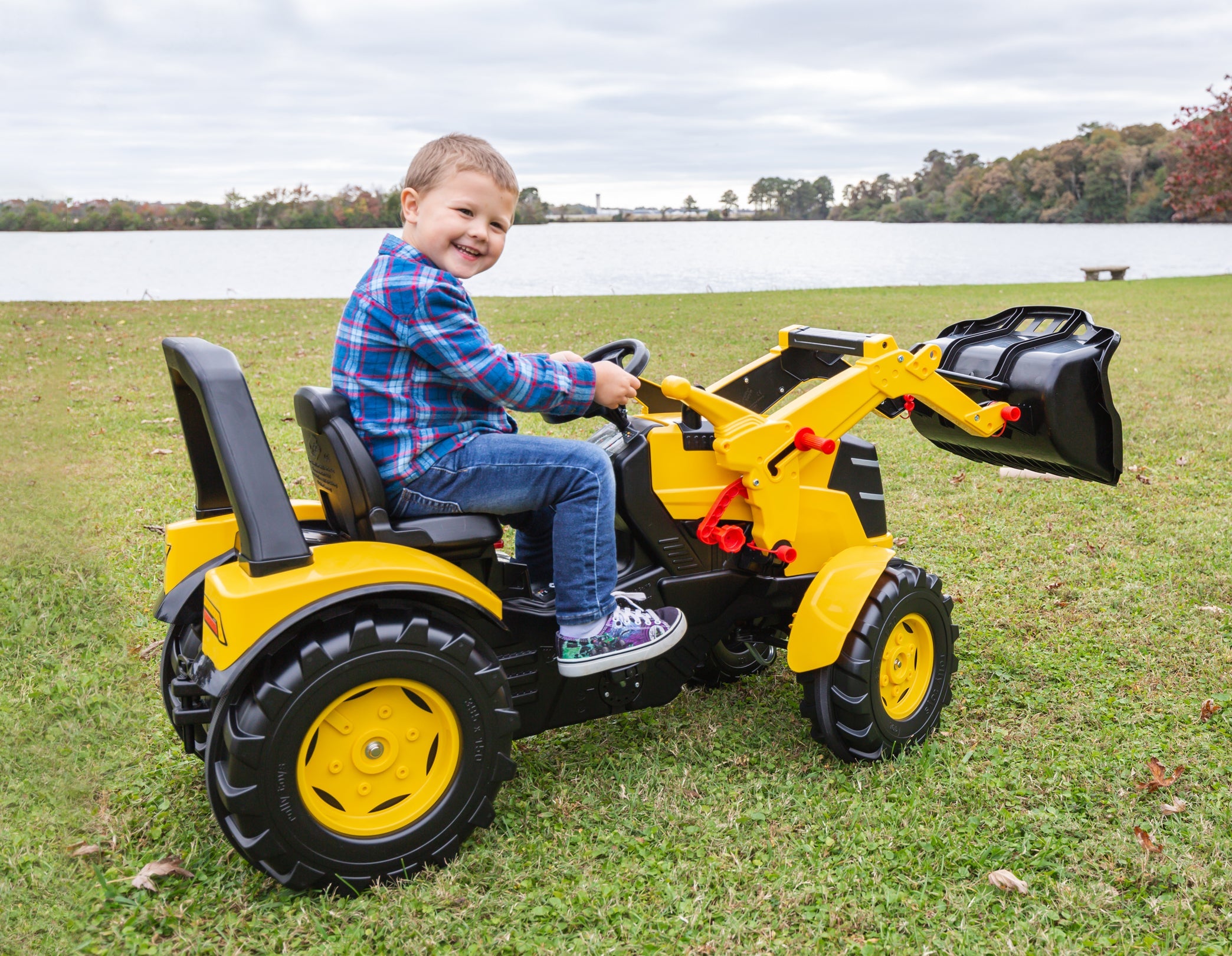 Child rides on toy tractor