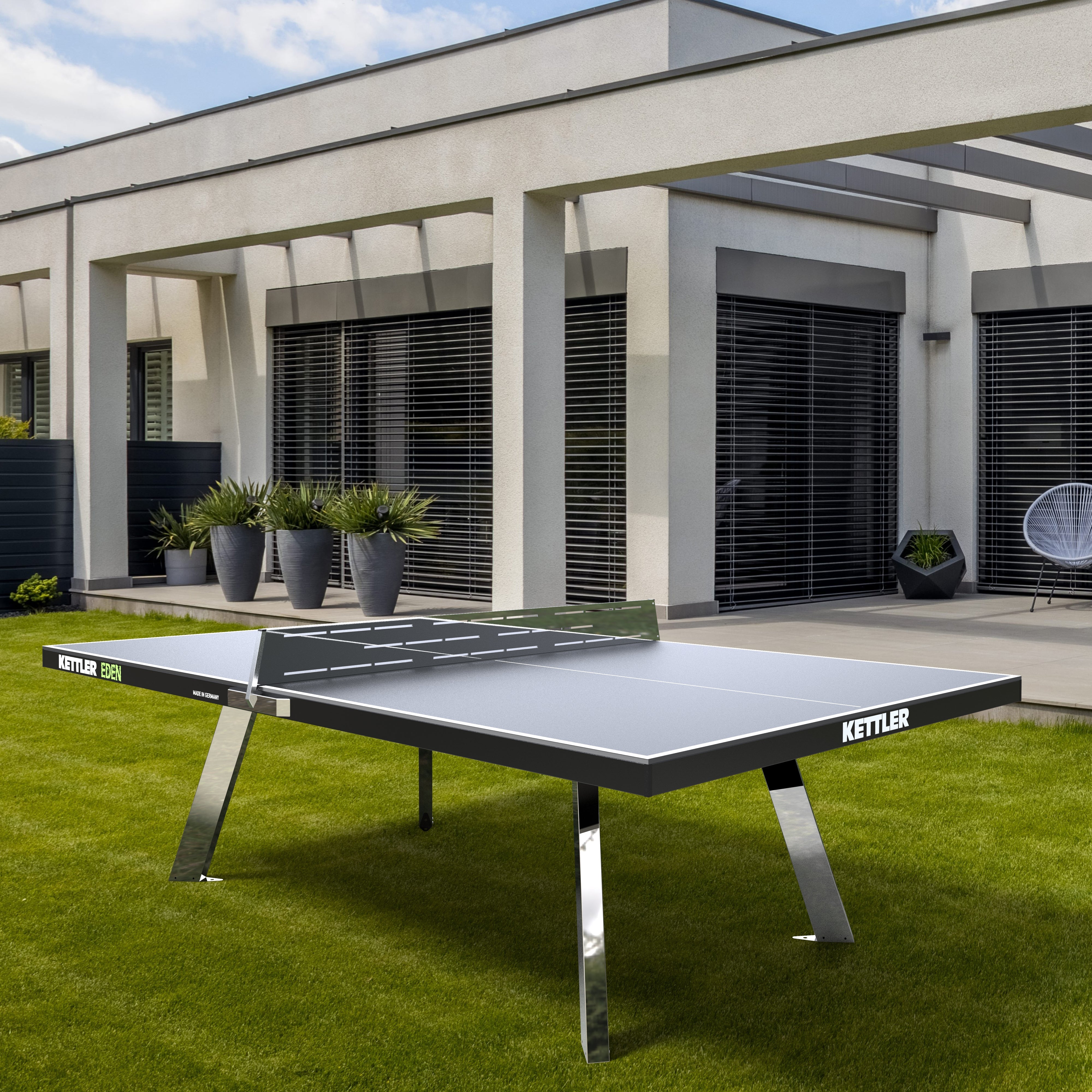 Lifestyle shot of stationary ping pong table in backyard 