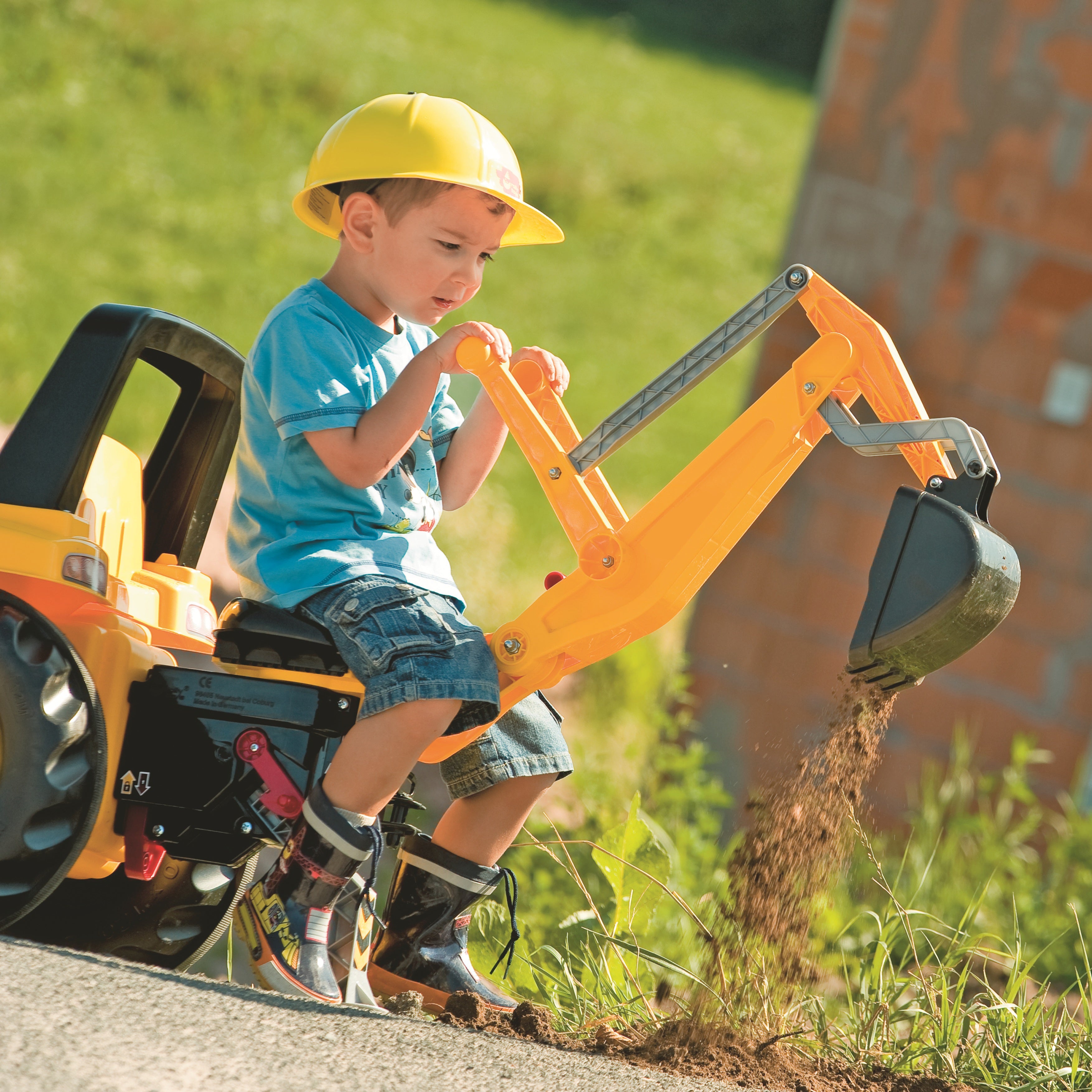 Lifestyle shot of child using german built digger accessory on tractor 