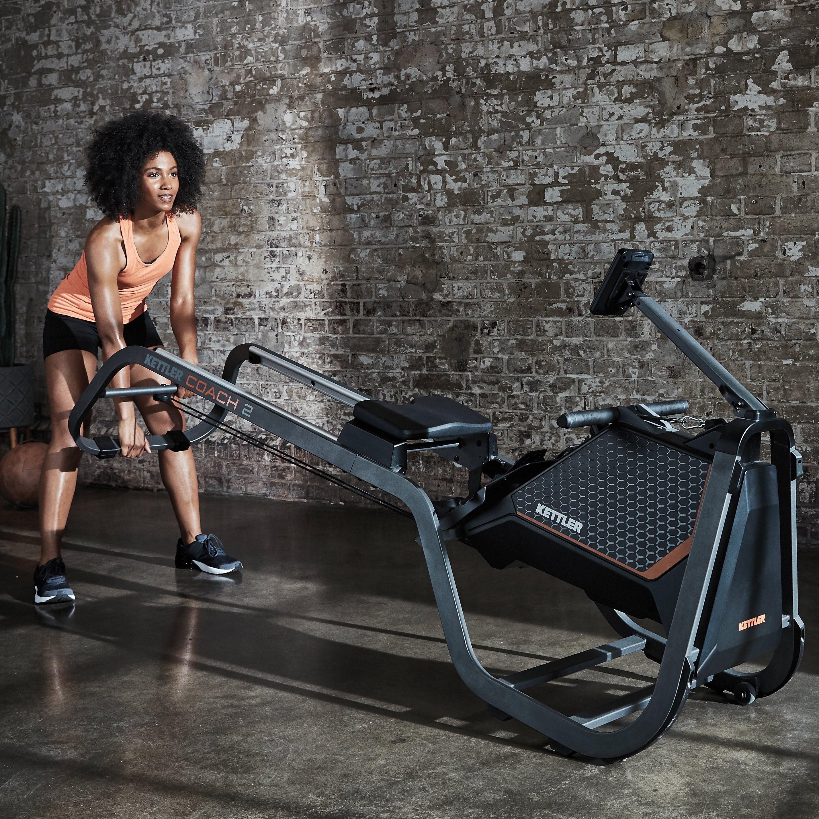 Lifestyle image of the Coach 2 Rowing Machine being transported by model.